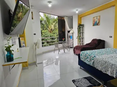 a bedroom with a bed and a television in a room at PIERO HOUSE - La Merced in La Merced