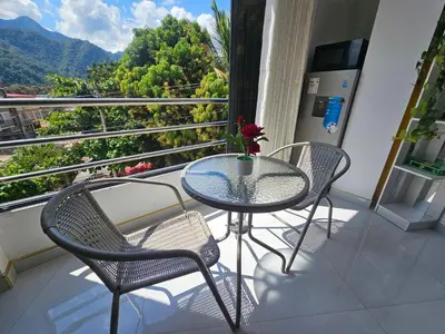 a table and chairs on a balcony with a view at PIERO HOUSE - La Merced in La Merced
