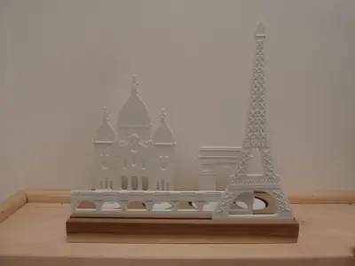 a model of the eiffel tower on a wooden shelf at La Maison Samaï in Urubamba