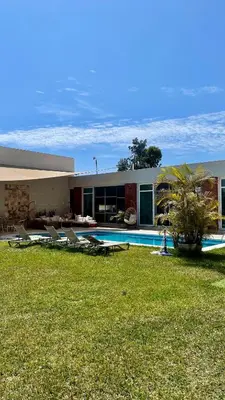 a house with a swimming pool and chairs in a yard at Casa Chocaya Playa Campo in Fundo Copacabana