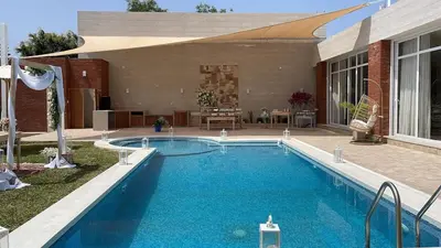 a large swimming pool in front of a house at Casa Chocaya Playa Campo in Fundo Copacabana