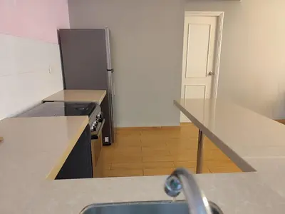 a kitchen with a sink and a stove and a refrigerator at Apartamento Limas Airport in Lima