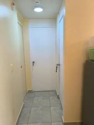 a hallway with a white door and a tile floor at apartment Campoy for tourist in Lima