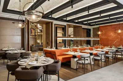 a dining room with tables and chairs and lights at InterContinental Real Lima Miraflores by IHG in Lima