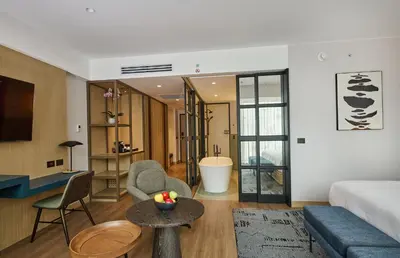 a living room with a couch and a table at Hotel Indigo Lima Miraflores by IHG in Lima