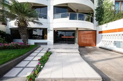a house with a palm tree in front of it at M1001 - Malecon Seaview 2BDR Miraflores in Lima