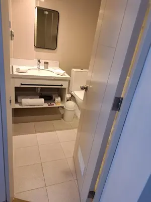 a bathroom with a sink and a toilet and a mirror at Venue Apartments in Lima