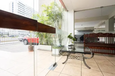 a glass table and a bench in a building at Reducto - Beautiful 3 BRD Front of Miraflores biggest Park in Lima
