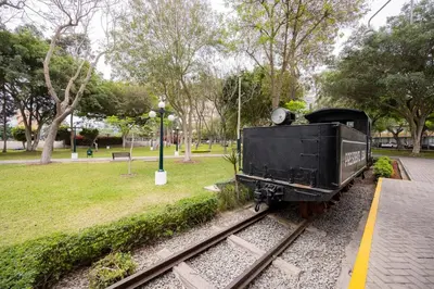 a train car sitting on the tracks in a park at Reducto - Beautiful 3 BRD Front of Miraflores biggest Park in Lima
