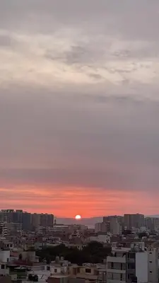 a city skyline with the sun setting in the sky at Apartamento moderno en San Miguel in Lima