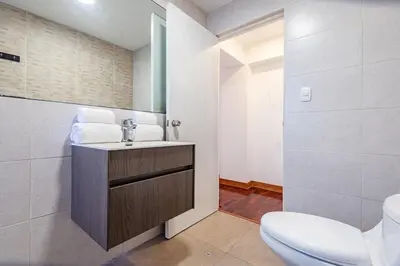 a bathroom with a sink and a toilet at Benavides - Amplio departamento funcional de 3 hab en Av Principal in Lima
