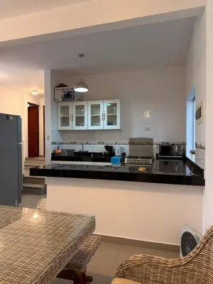 a kitchen with a counter top and a refrigerator at Beach house Sol Mar y Relax in Cerro Azul
