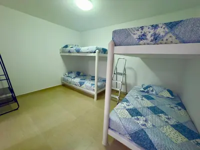 a room with two bunk beds and a ladder at Beach house Sol Mar y Relax in Cerro Azul