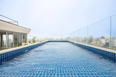 a swimming pool on the roof of a building at Balta - Apartment with Panoramic View in Kennedy Park in Lima