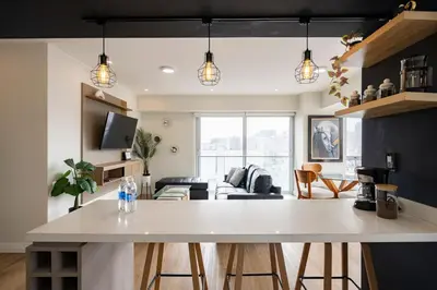 a kitchen and living room with a white counter top at Balta - Apartment with Panoramic View in Kennedy Park in Lima