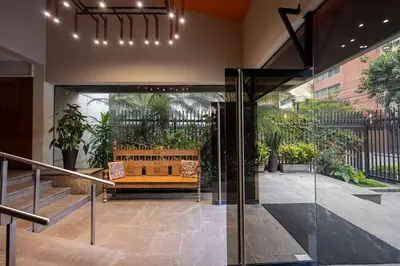 a lobby with a bench in a building with plants at GRM308 Bright 2BR with BIG Terrace in Heart of Miraflores in Lima