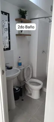 a bathroom with a white toilet and a sink at Dpto de Playa Miramar San Bartolo in San Bartolo