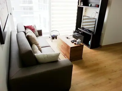 a living room with a couch and a coffee table at Wasi Apartment Pardo in Lima