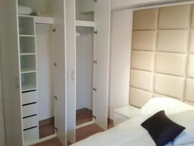 a bedroom with a bed and a large mirror at Peru Rent Apart com pe in Lima