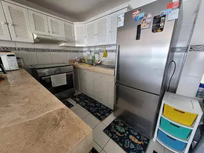 a kitchen with a stainless steel refrigerator and white cabinets at Departamento amplio en punta hermosa frente al mar in Punta Hermosa