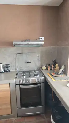 a kitchen with a stove and a counter with a counter top at Casa Catahuasi , Sacred Valley ,Urubamba,Cusco, Peru in Urubamba