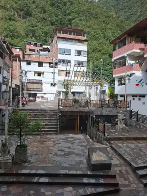 a courtyard with stairs and buildings in a city at Kuntur House Machupicchu in Machu Picchu