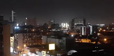 a city skyline at night with lit up buildings at 10p dpto in Lima