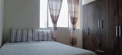 a bedroom with a bed and a window with curtains at 10p dpto in Lima