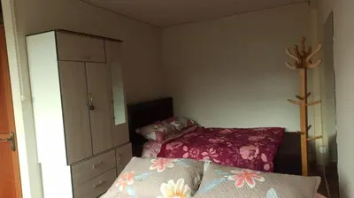 a small room with a bed and a dresser at Depawanka habitacion amoblado in Huancayo