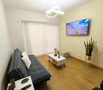 a living room with a couch and a table at Departamento en Santa Catalina cerca a San Isidro in Lima