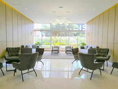 a waiting room with chairs and tables in a building at Departamento en Santa Catalina cerca a San Isidro in Lima