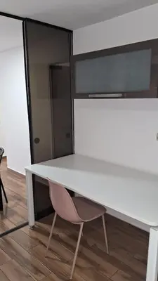 a white desk with a pink chair sitting under it at El Derby 511 Aparts de 3 Dorm con Aire Acondicionado in Lima