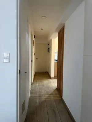 an empty hallway with white walls and wood floors at molero in Lima