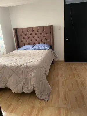 a bedroom with a bed and a wooden floor at Mirador Vip Apartment in Cusco
