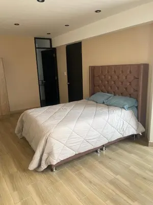 a large bed in a bedroom with a wooden floor at Mirador Vip Apartment in Cusco