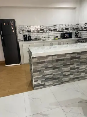 a kitchen with a black refrigerator and a counter at Mirador Vip Apartment in Cusco