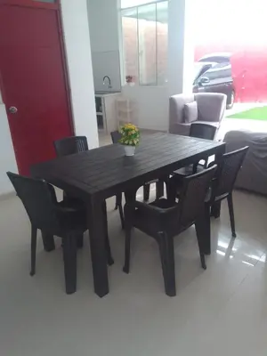 a black table and chairs with a vase of flowers on it at Casa, Playa el pasamayito sur de asia in Asia