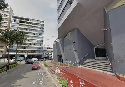 a red car parked in front of a building at Apartment in Lima in Lima