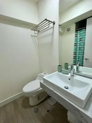 a white bathroom with a sink and a toilet at Art28 Studio Apartment in Lima