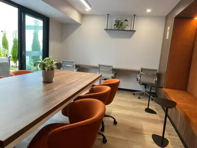 a conference room with a large wooden table and chairs at Art28 Studio Apartment in Lima