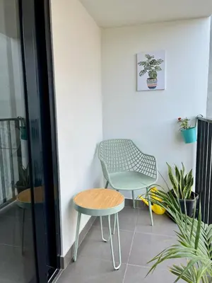 a chair and a table and a chair in a room at Art28 Studio Apartment in Lima