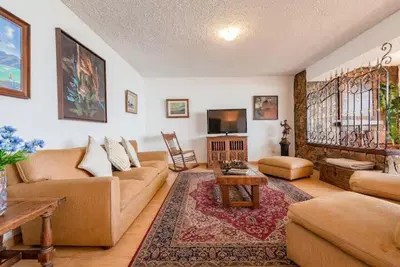 a living room with a couch and a table and a tv at M701 Malecón View Apartment 3 BDR in Lima