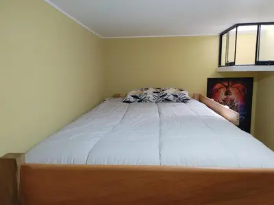 a bedroom with a large bed with a white bedspread at Habich Apartment in Lima