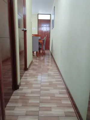 a hallway with a table and a dining room at Habich Apartment in Lima