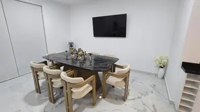 a dining room with a black marble table and chairs at Casa de Playa de Estreno in Cerro Azul