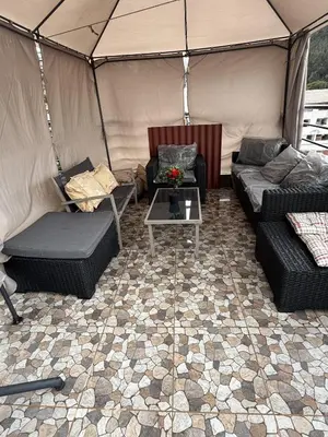 a room with two couches and a table in a tent at Chabela Host in Cusco