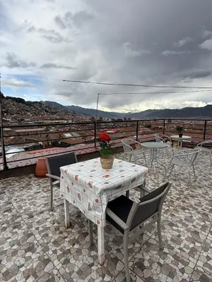 a table and chairs on a patio with a view at Chabela Host in Cusco