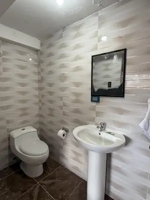 a bathroom with a sink and a toilet and a mirror at Chabela Host in Cusco