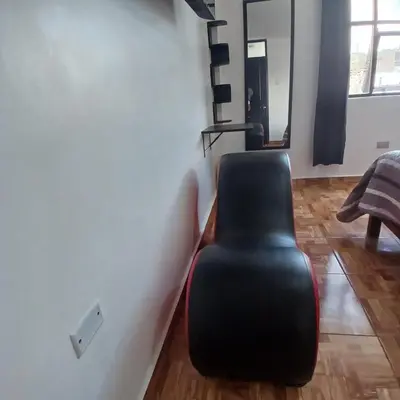 a black chair sitting in the corner of a room at HOSTAl EGIPTO in Ayacucho