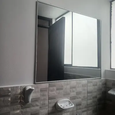 a bathroom with a large mirror and a sink at HOSTAl EGIPTO in Ayacucho